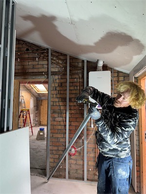Plasterer prepping the wall